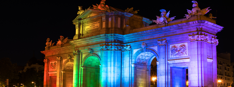 rainbow lights on a stone gate