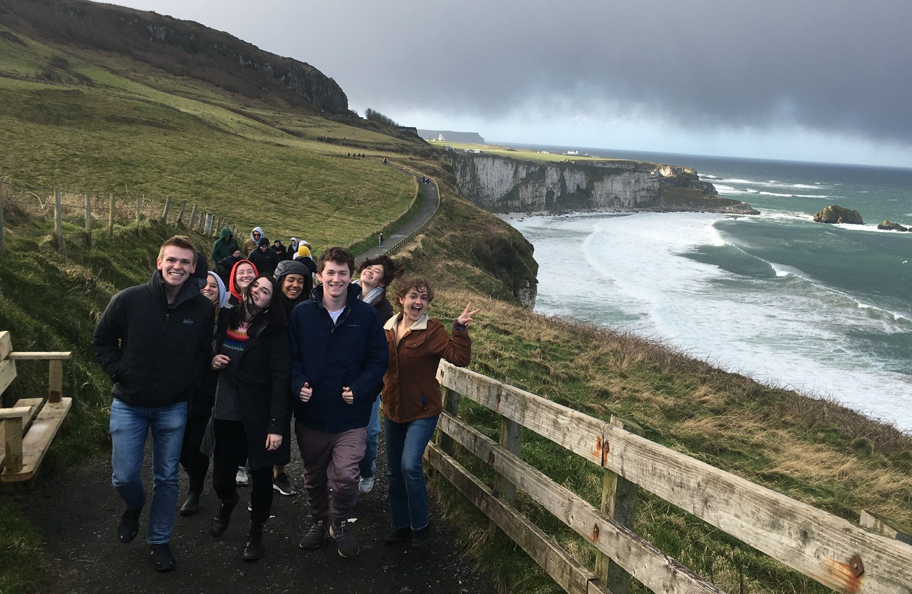 Group of studetns walking on a path on the coast of ireland