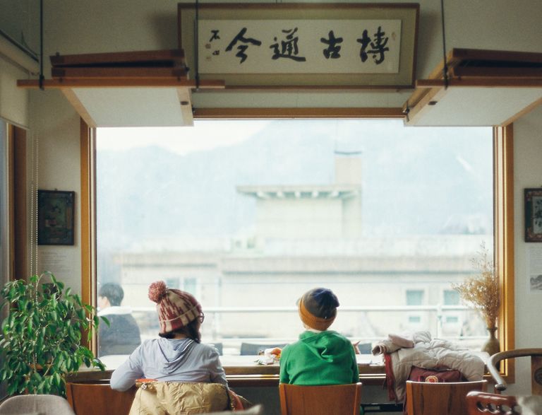 2 people sitting in a cafe in fron of a window in Seoul South Korea