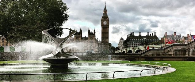 fountain in a park in the foreground big ben in background