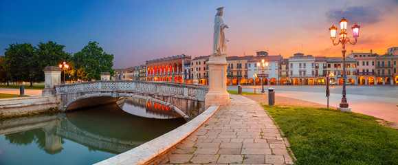 Panoramic cityscape image of Padua, Italy with Prato della Valle square during sunset.