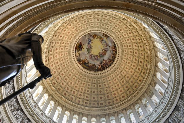 The dome inside of US Capitol in Washington DC beside the statue of George Washington.