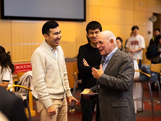 Master lecturer Richard Maltzman chats with students at a networking event