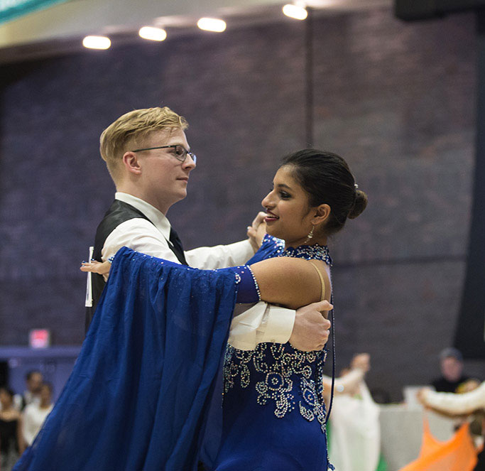 Luke Jones (CAS) (left) and Ballroom Dance Club president Nikita Varman (CAS, SAR) competing in the rhythm category at the Terrier Dancesport competition in the Metcalf Ballroom.