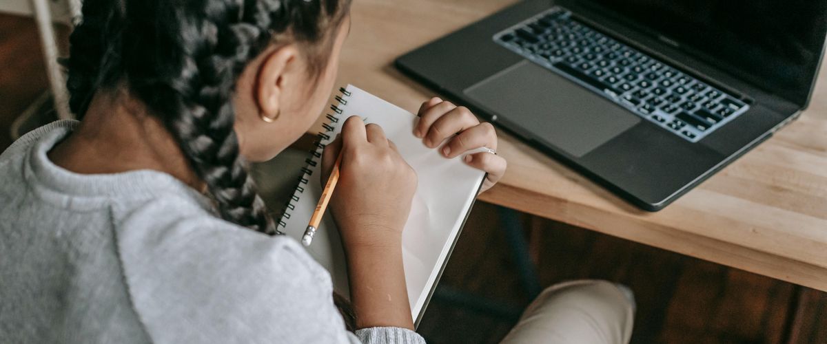 Student writing in a notebook