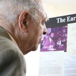 Professor Emeritus James Teele reads an exhibit on the early years of the African American Studies Program, designed by African American Studies Graduate Assistant Melanee Harvey
