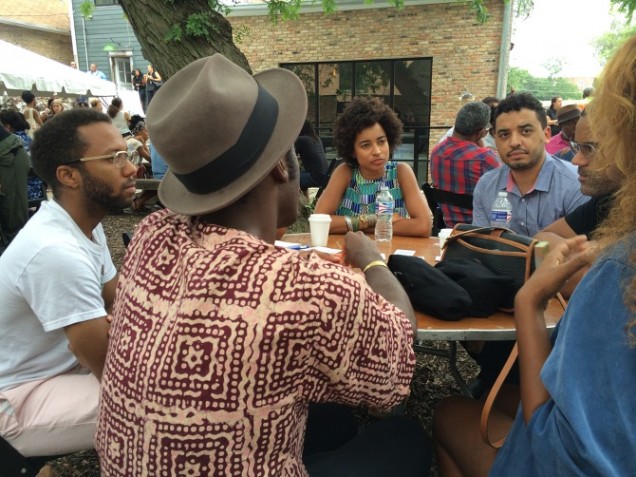 A group of black artists sitting around a table during 'Black Lunch Tables'