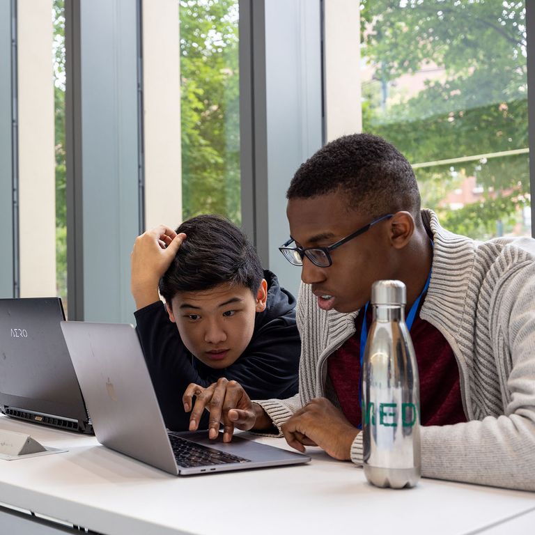 Two people working collaboratively on a computer