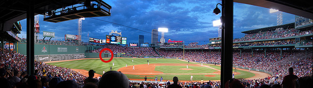 The Bleacher Bar sits unobtrusively below the famous Green Monster outfield wall, free of distracting the players and batter. (Getty Images)