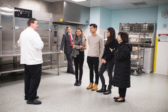 A SHA student team gets a tour of the kitchens at the Boston Convention and Exhibition Center: Tim Elderkin (from left), executive sous chef, Milt Herbert, executive director of the Boston Convention Marketing Center, Julie MacKay, Wei-Chi Victor Su, Sabrina Avila, and Yun-Ting Emily Lai. Photo by Jackie Ricciardi