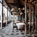 Interior dining area of a restaurant showcasing its aesthetic wood design and the set up of tables