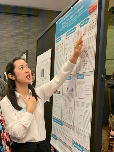 Victoria presenting her research at the annual UROP symposium. She is pointing out her poster.