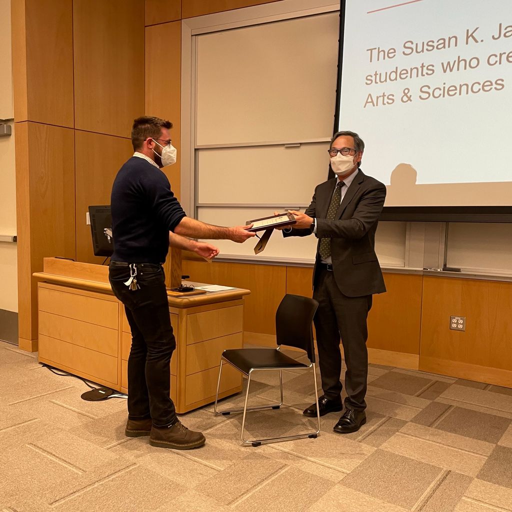 Dr. Chris Schmitt receiving the Susan K. Jackson award from Dean of CAS, Stan Sclaroff