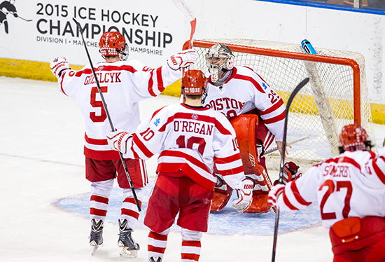 Frozen Four, here we come! Terriers Matt Grzelcyk (COM'16), Danny O'Regan (COM'16), and Doyle Somerby (CGS'15) converge on goalie Matt O'Connor (SMG'16) after BU's 3-2 win over Minnesota Duluth in Saturday's NCAA Northeast Regional final in Manchester, N.H. The Terriers are on their way to the NCAA championship at Boston's TD Garden April 9 and 11. Photo by Brian Kelley/BU Athletics
