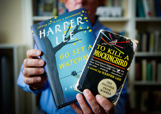 Boston University professor John T. Matthews holding copies of the books Go Set a Watchman and To Kill a Mockingbird by Harper Lee