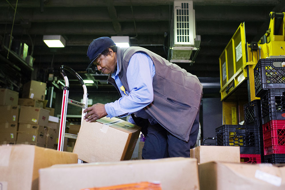 Lee Morris, who has worked at BU Dining Services for 55 years and who is about to receive an award from Aramak loads food supplies the GSU on September 22, 2015  Photo By Jackie Ricciardi for Boston University Photography