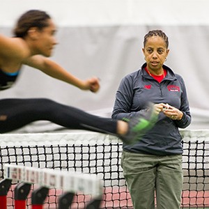 Robyne Johnson, track and field director at Boston University, watches track team members do hurdles during a team practice