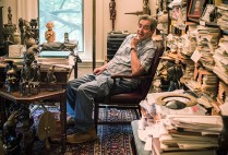 Stephen Grossberg, sitting in a chair in his home in Newton