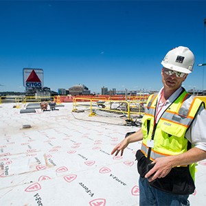 Al Hartshorn, Shawmut Design and Construction senior project superintendent, stabds on Myles Standish Hall new roof