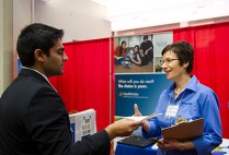 A student speaking with a host a the BU's Center for Career Development career fair