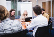 Cathie Jo Martin and intern Ben Getchell sitting in a room at a meeting