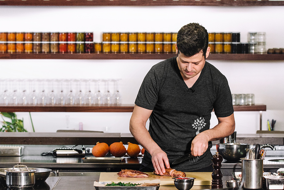 Peter Ungár in the kitchen preparing a duck dish