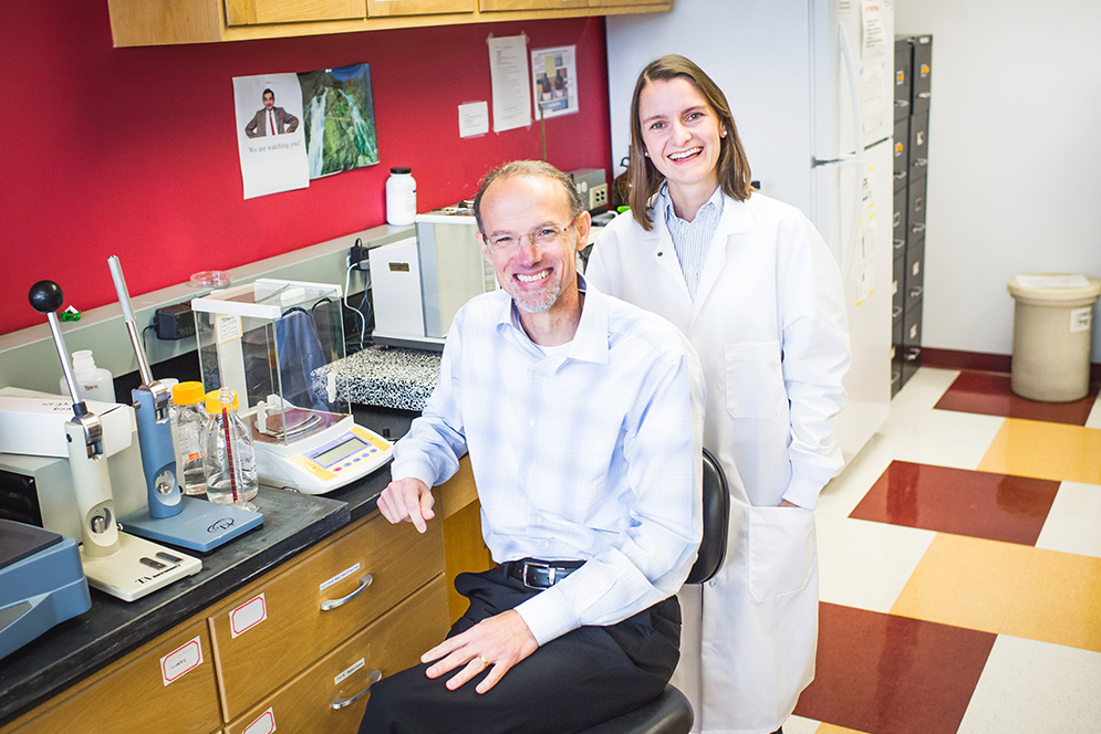 Mark Grinstaff and Marlena Konieczynska pose for a photo in their lab