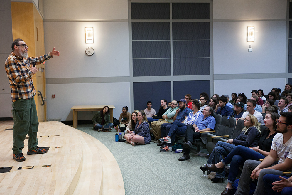 Larry Charles speaks to a crowd at the Photonics Center auditorium