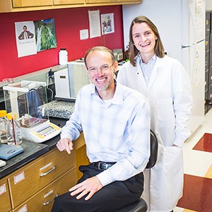 Mark Grinstaff and Marlena Konieczynska pose for a photo in their lab