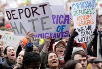 Demonstrators display pro-immigrant signs at the Boston Protest Against Muslim Ban and Anti-Immigration Orders, January 29, 2017 in Copley Square, Boston