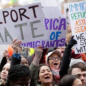 Demonstrators display pro-immigrant signs at the Boston Protest Against Muslim Ban and Anti-Immigration Orders, January 29, 2017 in Copley Square, Boston