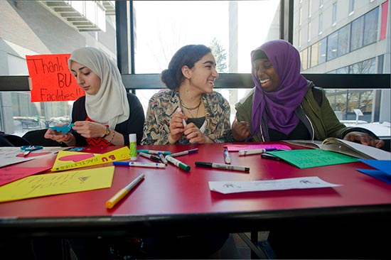 In 2015, campus Muslims, including (left to right) Sara Parvin-Nejad (CAS'15), Diana Abbas (CAS'18), and Amina Egal (CGS'17), made thank-you cards to BU facilities workers who helped students during a snowstorm.