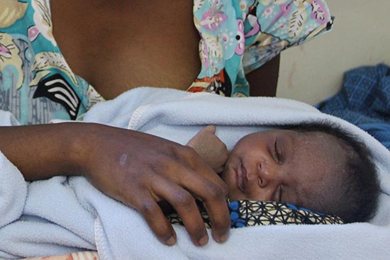 A mother in sub-Saharan Africa holds her infant