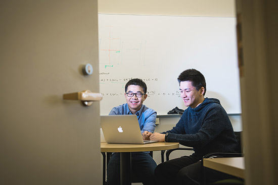 Dan Li, a CAS assistant professor of Earth and the environment (left), and Yaofeng Gu (CAS'17) are working on a model to help predict how temperatures in cities will change in the future. Their work will be used in the next Intergovernmental Panel on Climate Change. Photo by Jackie Ricciardi