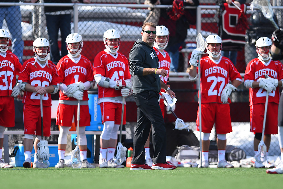 Head Coach Ryan Polley coaches from the sidelines during a BU Terriers lacrosse game