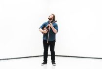 Contemporary music composer Nicholas Quigley poses with violin