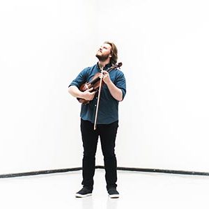 Contemporary music composer Nicholas Quigley poses with violin