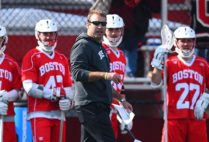 Head Coach Ryan Polley coaches from the sidelines during a BU Terriers lacrosse game