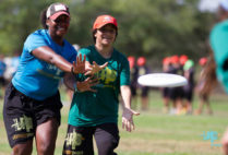 Dana Dunwoody with youth reaching for mid-air disc
