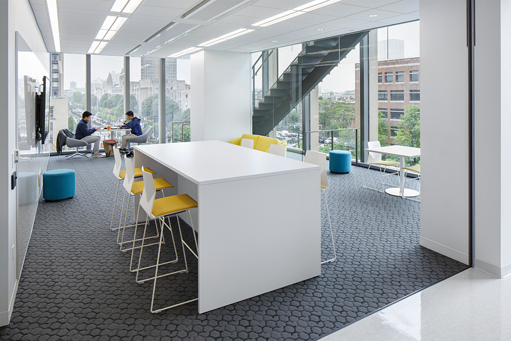 A community meeting space near the communicating staircase in the Rajen Kilachand Center for Integrated Life Sciences and Engineering science building at Boston University, which is built to encourage collaborative research and interaction