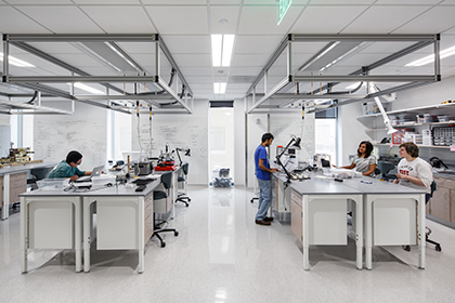 People work in the Design, Automation, Manufacturing, Prototyping lab (DAMP lab) at the Rajen Kilachand Center for Integrated Life Sciences and Engineering science building at Boston University