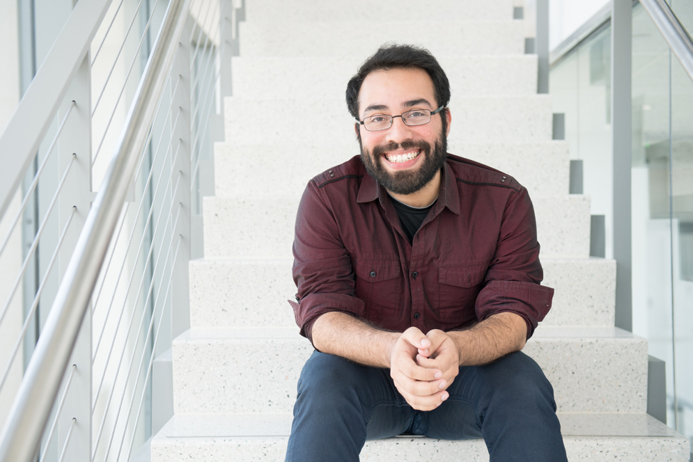 Steve Ramirez sitting on a white staircase
