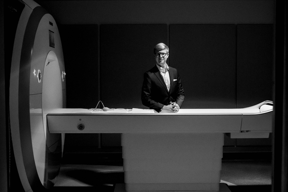 Neuroscientist Tyler Perrachione, poses with the Siemens Prisma 3 Tesla MRI scanner in the Cognitive Neuroimaging Center at the Rajen Kilachand Center for Integrated Life Sciences and Engineering at Boston University