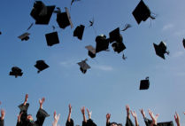 graduation caps in the air