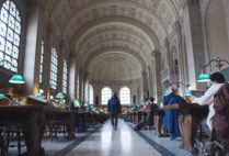Charles Lewis walks through the Boston Public Library