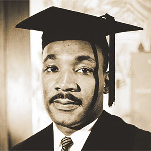 Portrait of Martin Luther King Jr, in a graduation robe and mortarboard hat upon receiving an honorary degree from Boston University in 1958