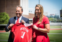 Drew Marrochello, BU athletics director, welcomed Lauren Morton (CAS’08) as BU’s new women’s lacrosse coach with a jersey featuring her number from her University playing days. Photo by Jackie Ricciardi