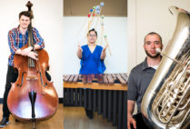 BU music students pose with the oversized instruments they play.