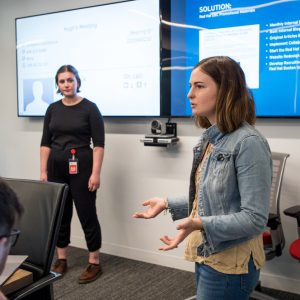 Grace Colbert (CFA’19) (left) and Fiona Whittington (COM’19) talk about projects in progress to fellow interns and Red Hat staff at a lunchtime series at the company’s offices in the Seaport District.