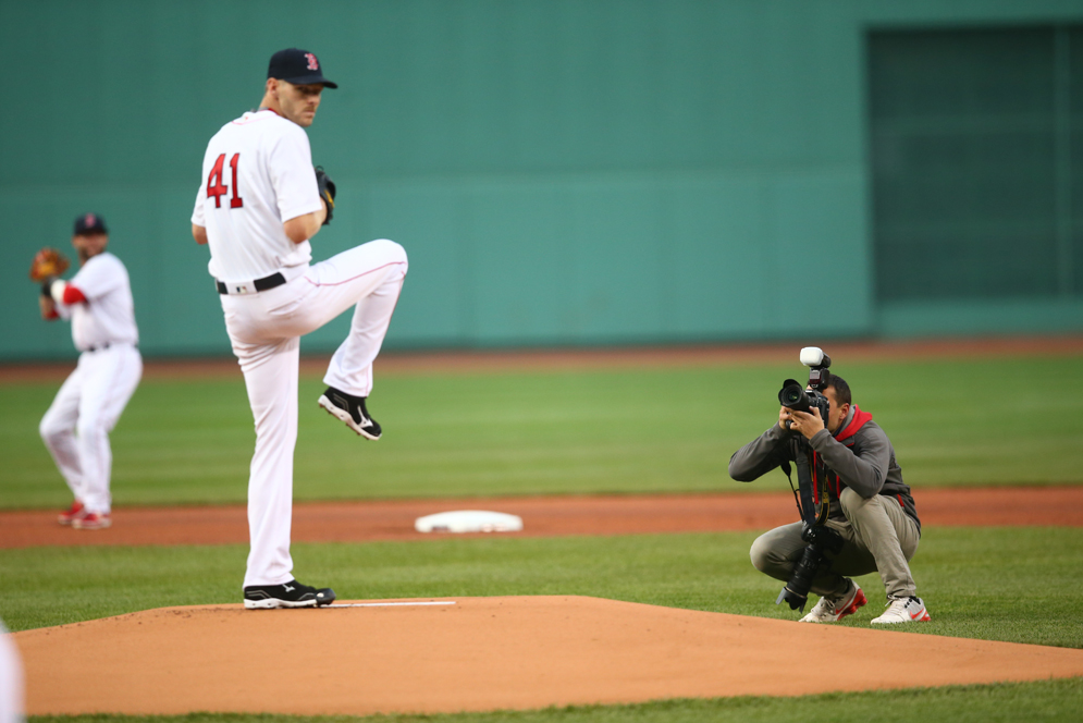 Weiss crouches down behind the pitchers mound to get a shot.
